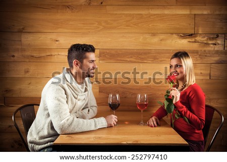 Young couple sitting in a restaurant having romantic dinner