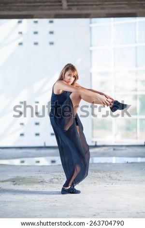 Contemporary ballet dance pose performed by attractive young woman