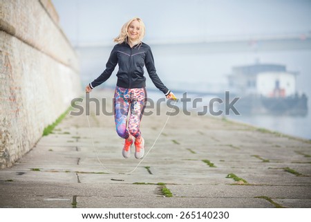 Woman exercising outdoors with a jump rope