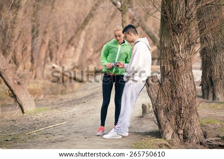 Young couple taking a break during physical activities in nature