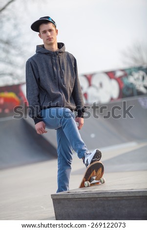 Teenage boy skateboarding in a skateboard park