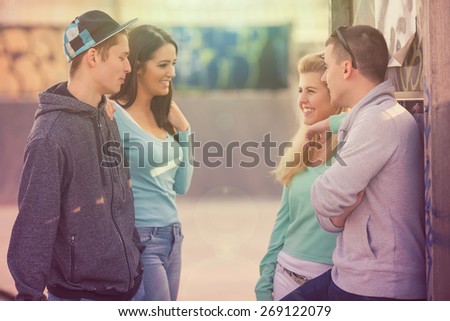 Group of teenagers hanging out in the skate park or schoolyard