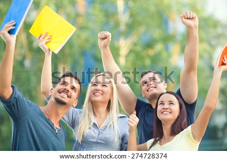 Group of happy students celebrating their success