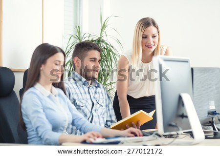 Business people analyzing their work in front of the computer