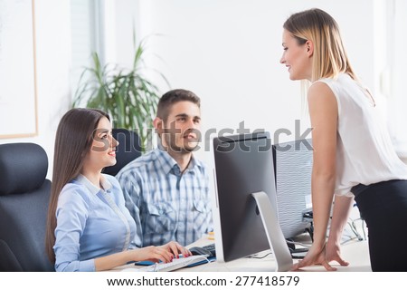 Lady boss with her coworkers in a office