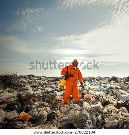 Recycling worker measuring pollution on the landfill