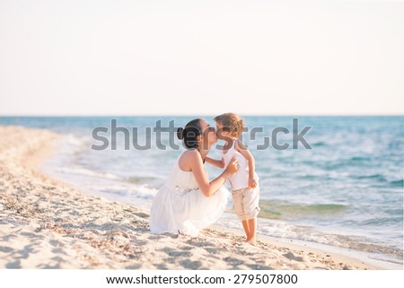 Mother and son kissing on the beach