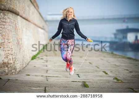 Woman exercising outdoors with a jump rope