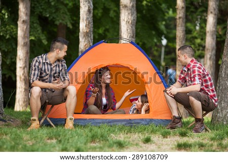 Young people having fun camping in a forest