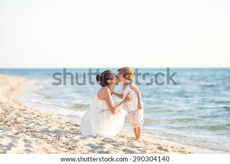 Mother and son kissing on the beach