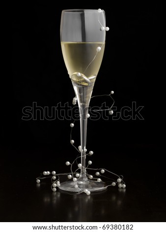 stock photo Glass of white wine with wedding rings and pearls as 