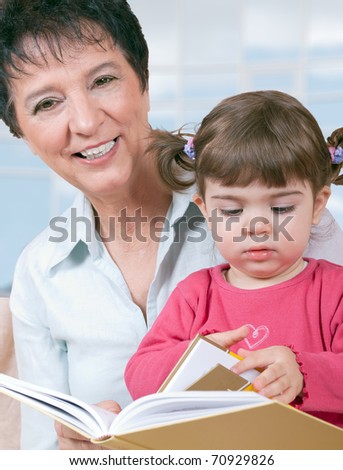 Cute girl reading with grandma