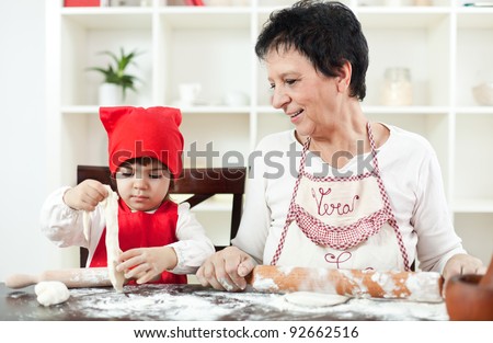 Grandma cooking with her little granddaughter