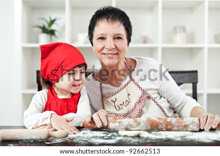 Grandma cooking with her little granddaughter