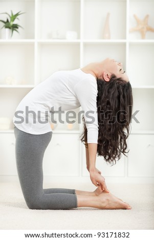 Beautiful young woman in yoga position