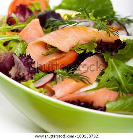 Smoked salmon salad with red onion, egg, carrots and radishes. Selective focus.