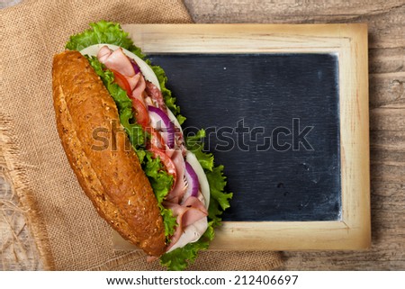 Deli sub sandwich with chalkboard. Selective focus.