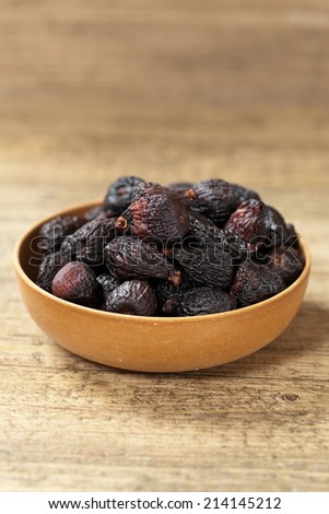 Black Figs (dried) on a wooden background. Selective focus.
