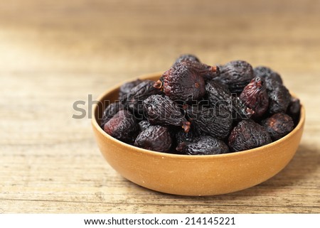 Black Figs (dried) on a wooden background. Selective focus.