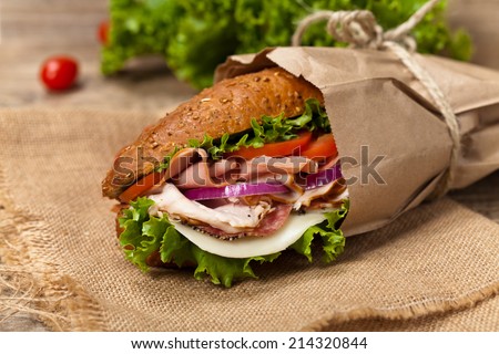 Italian Sub Sandwich with Salami, Tomato, and Lettuce. Selective focus.