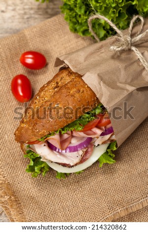Italian Sub Sandwich with Salami, Tomato, and Lettuce. Selective focus.
