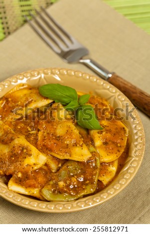 Cheese and spinach stuffed ravioli pasta with tomato sauce and parmesan cheese. Selective focus.