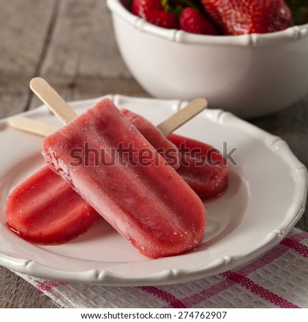 Frozen Strawberry Fruit Bars on old wooden background. Selective focus.