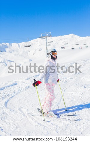 Young girl in ski outfit in the Zillertal Arena, Austria. Vertical view