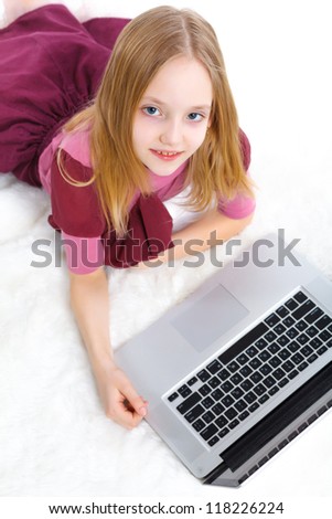 Attractive young girl using notebook computer. Isolated on white background.