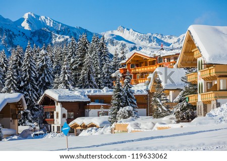 Snow-Covered Cottages At The Austrian Alps Of The Tyrol Region.