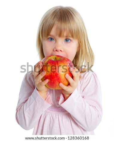 Little beauty girl eating big red apple. Isolated white background
