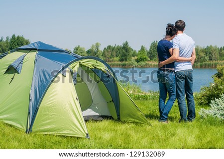 Holiday camping - Man And Woman Couple Camping near A Tent In The Countryside