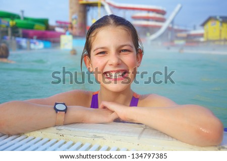 Activities on the pool. Cute girl swimming and playing in water in thermal hot pool