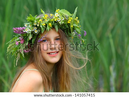 Clouse-up spring portrait beautiful girl with wreath of flowers