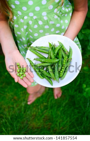 Young girl hand holding organic green natural healthy food produce green Peas