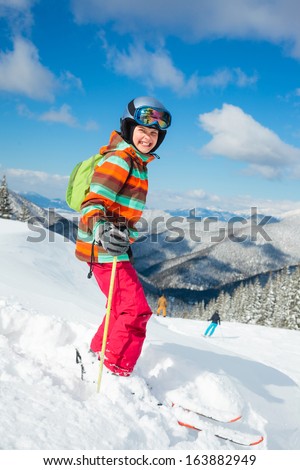 Girl on skis in soft snow in the mountains