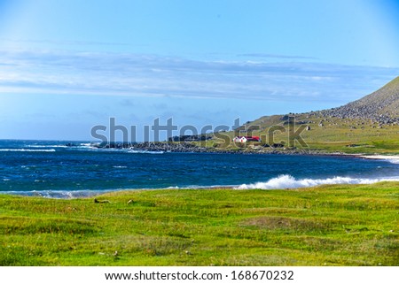 Iceland summer landscape. Ocean, house, mountains, meadow. Panorama