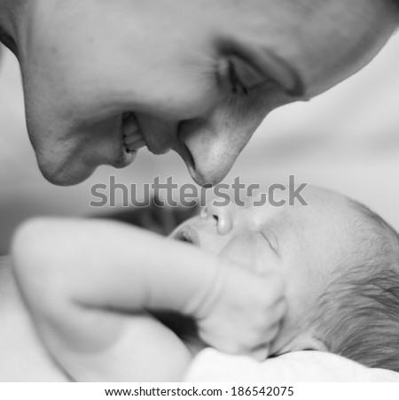 Closeup Portrait Mother and a newborn baby boy, 11 day old. Black-and-white photo