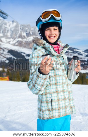 Ski, skier, winter. Lovely girl has a fun on ski - resting and drinking tea from a thermos.