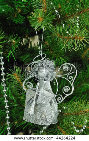 Beautiful Christmas tree toys silver angel on a Christmas tree branch