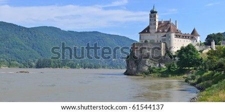 Panorama of the medieval castle on a river. Powerful medieval castle above the Danube. Austria
