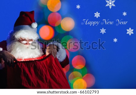 Santa sitting at the Christmas tree and looking into the sack