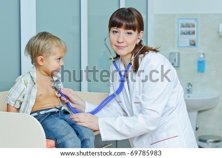 Young and cute female doctor visiting with a stethoscope a little boy