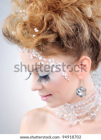 Closeup portrait of young beautiful girl with fantasy winter make-up