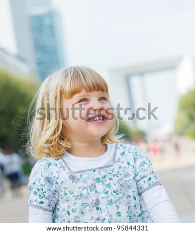 Portrait of the cute little girl walking to la Defense, Paris