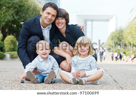 Happy family of four walking to la Defense, Paris.