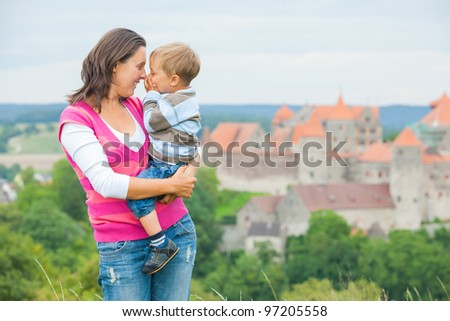 Young travelers. Young mother with her son on a tour of European medieval castles.