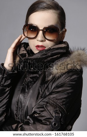 Closeup portrait of gorgeous young lady in sunglasses with jacket