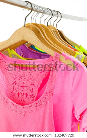 row of colorful shirt rack on wooden hangers