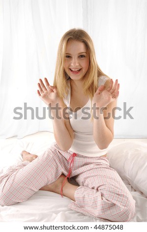 Portrait of young beautiful happy woman on bed